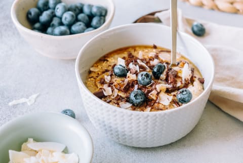 Porridge Topped With Caramelized Banana, Chocolate, Shredded Coconut And Blueberries Porridge Topped With Caramelized Banana, Chocolate, Shredded Coconut And Blueberries