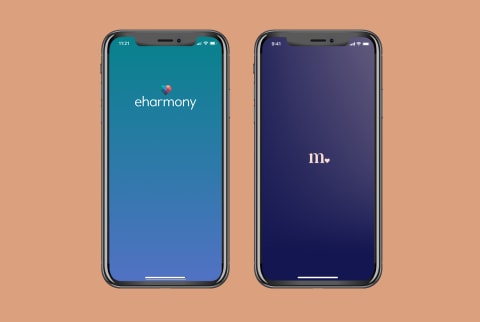 Two phones showing the Match and the eharmony logos on the screens. Two phones showing the Match and the eharmony logos on the screens.