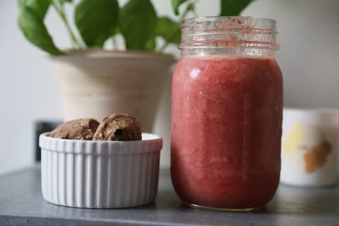 Daily harvest bites next to a blended smoothie in mason jar Daily harvest bites next to a blended smoothie in mason jar