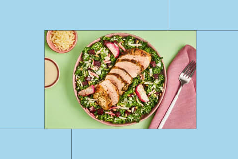 Green Chef meal of pork chop on kale salad in creative image Green Chef meal of pork chop on kale salad in creative image