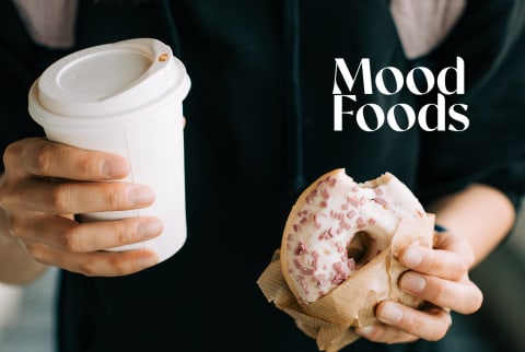 woman holding donut and coffee woman holding donut and coffee